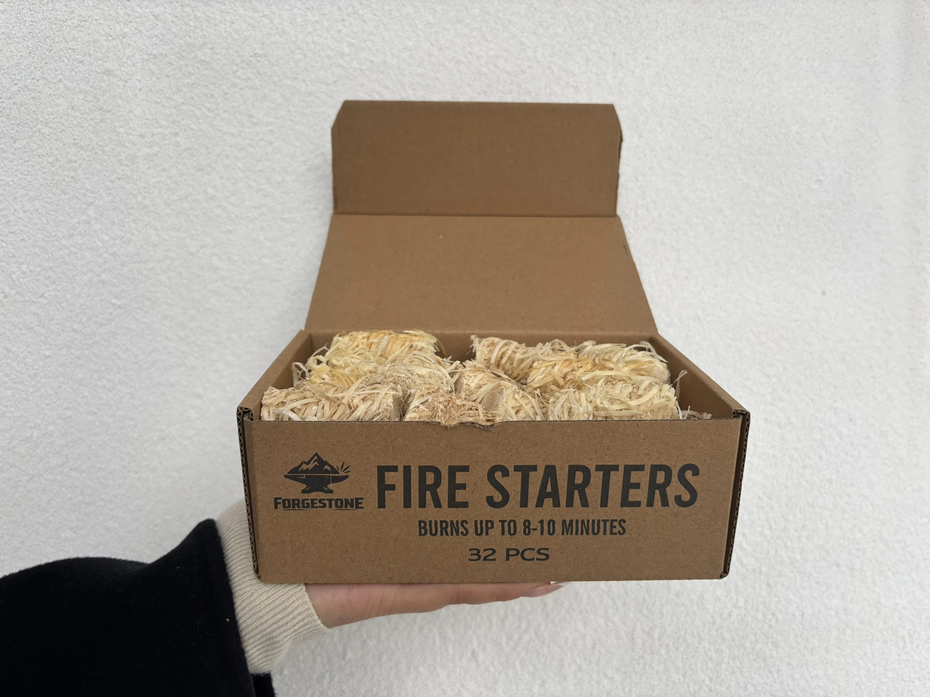 Open FORGESTONE box containing 32 natural wood wool fire starters